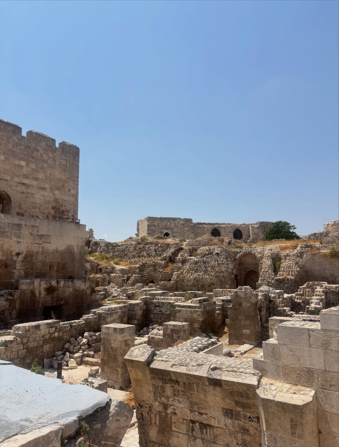 Stone ruins inside a citadel under a clear sky